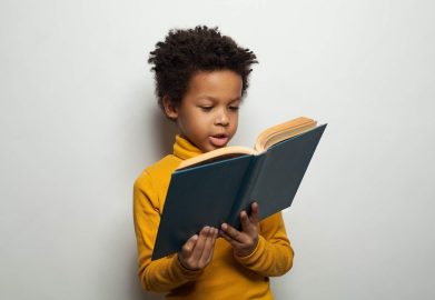 smart-black-child-boy-reading-book-white-background-174149392-transformed